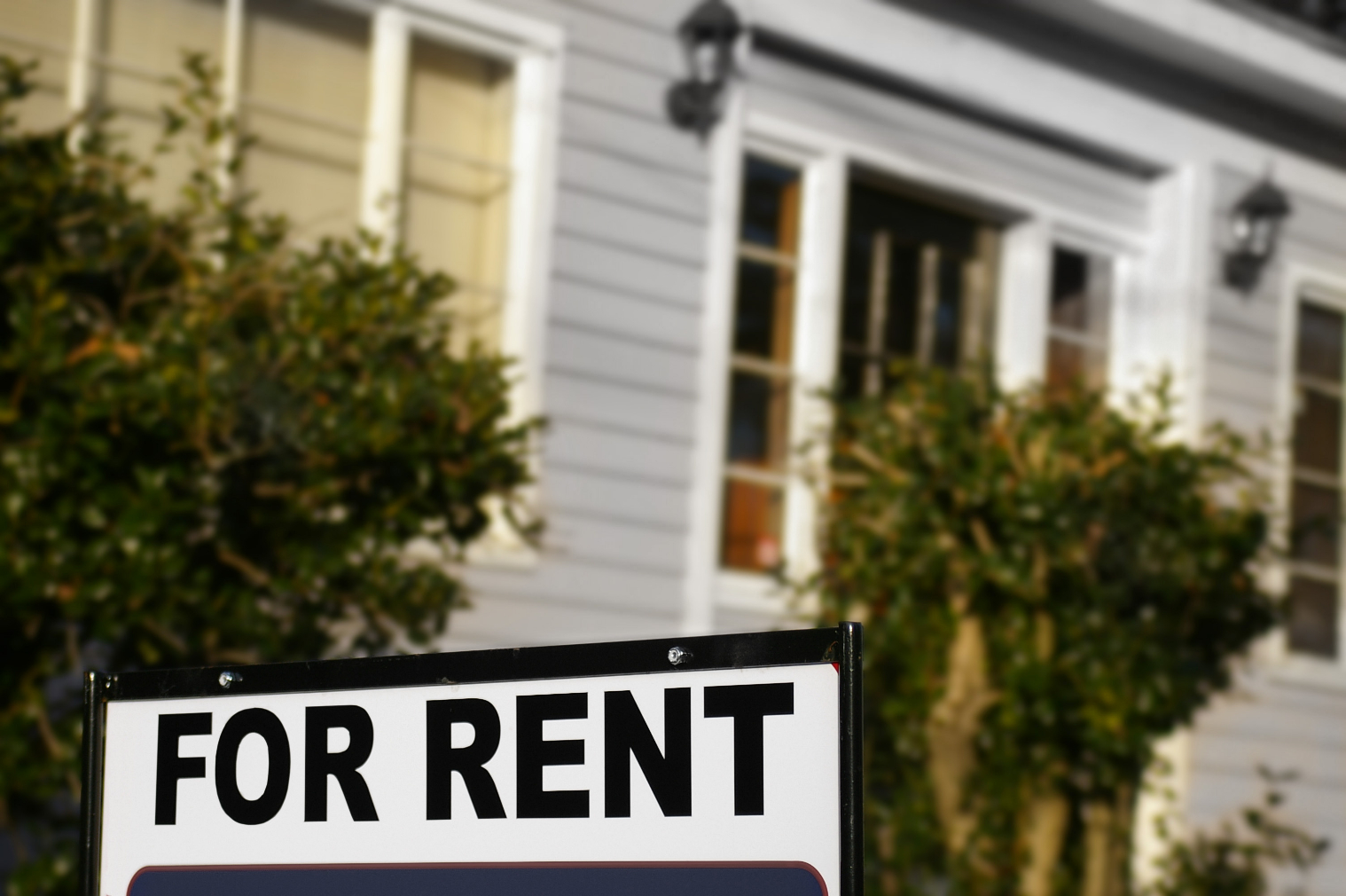 House with "For Rent" sign in front
