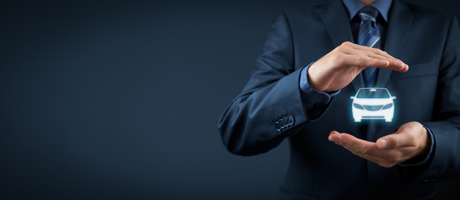man in a suit holding a symbol of a small car