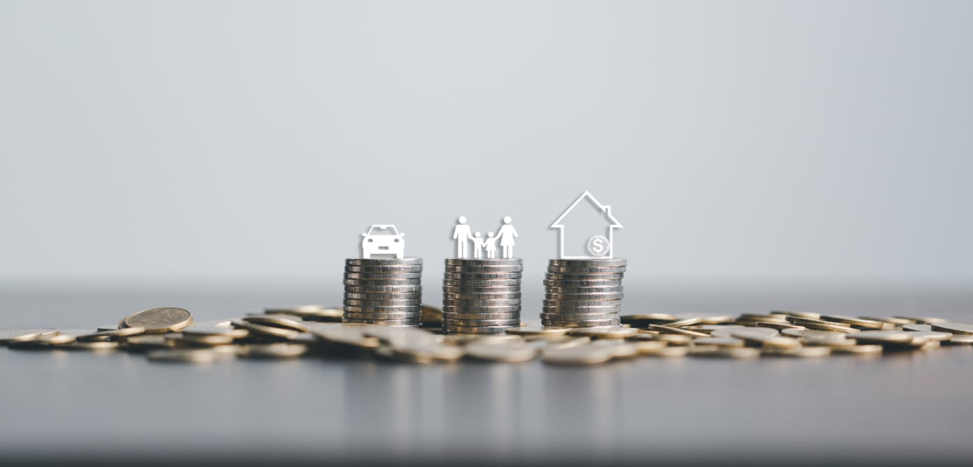 Pile of coins with small home care and family symbols