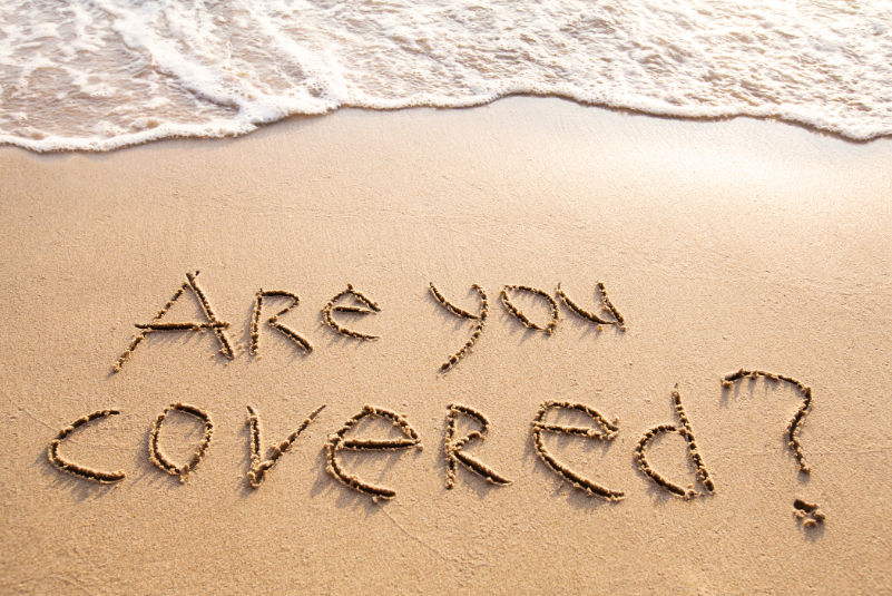 Writing on the sand that says "Are you covered?"