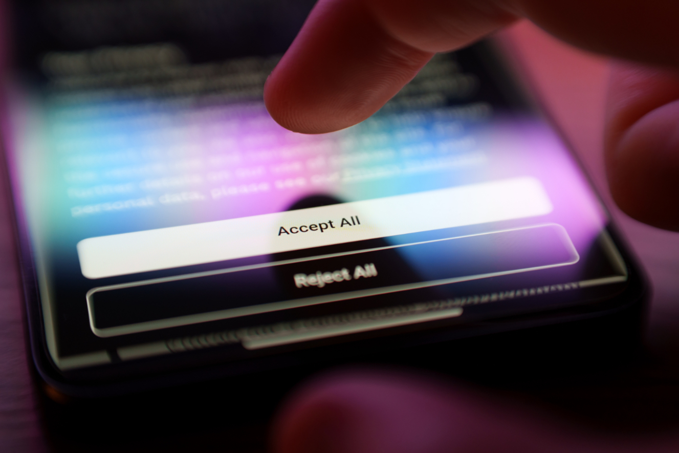 Close up of person clicking accept all as they enter website through phone.