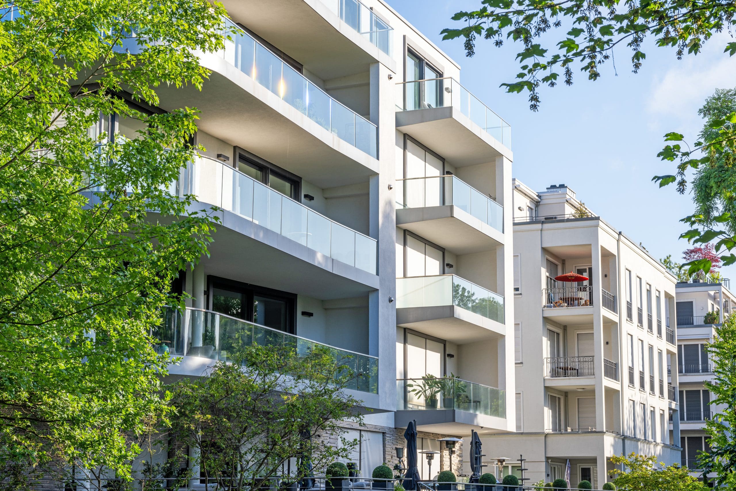 Modern condo buildings surrounded by greens.