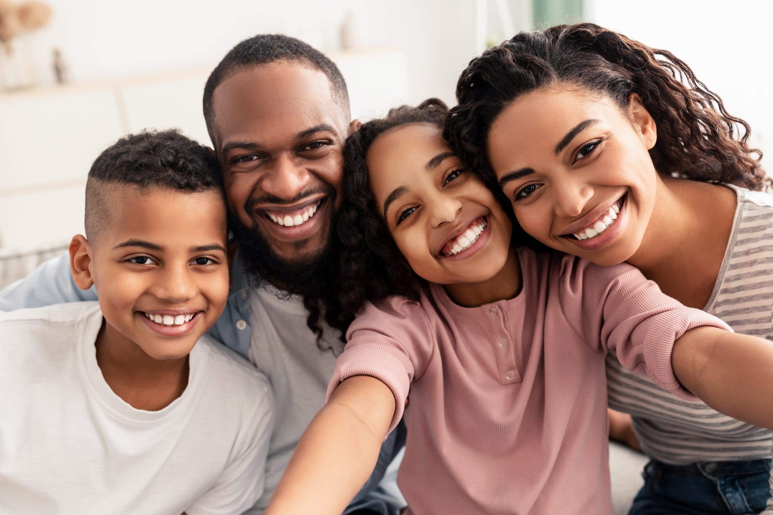 Portrait of happy loving black family of four people taking selfie together, closeup.