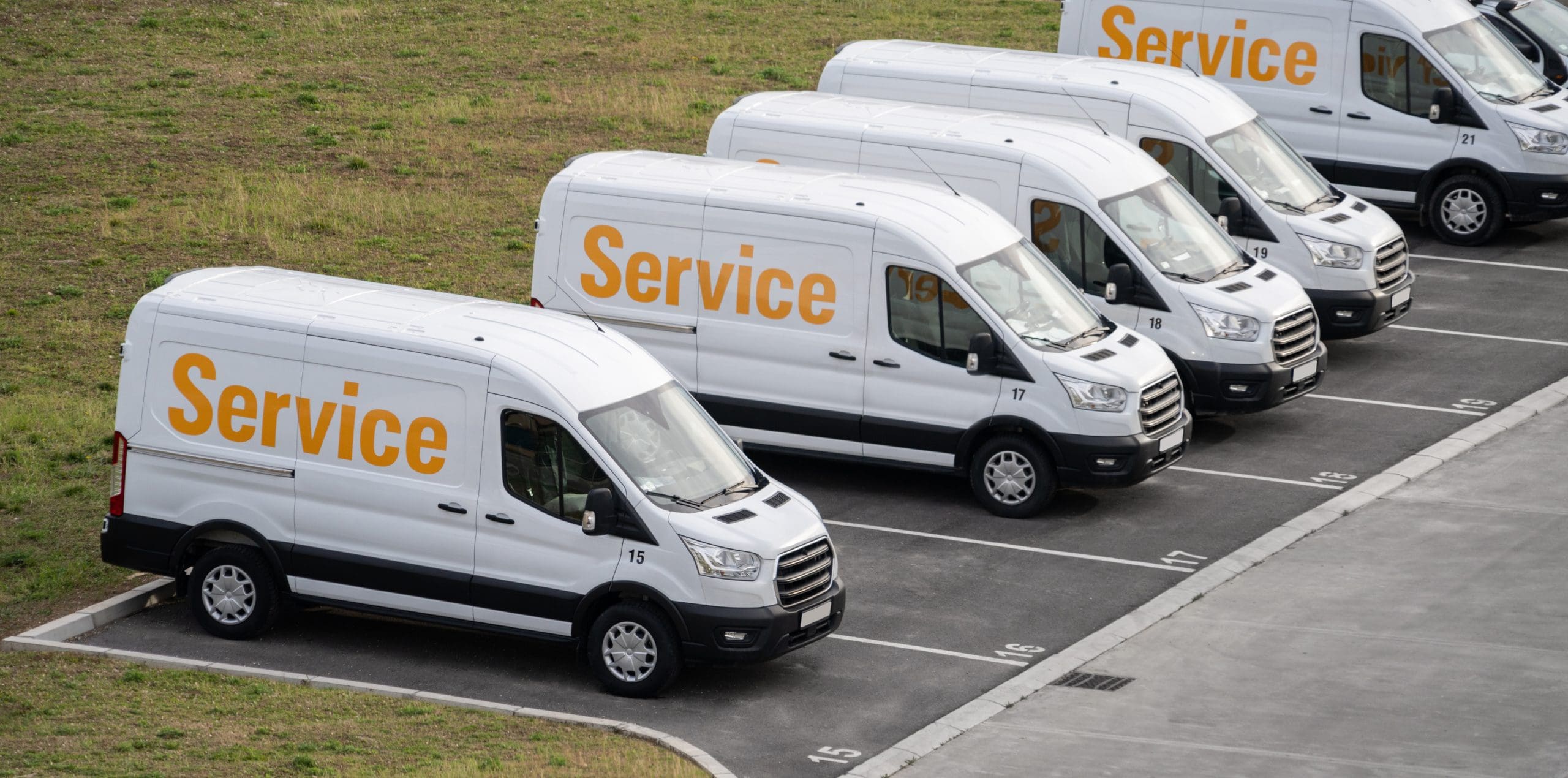 Service vans are parked in row. Commercial fleet,