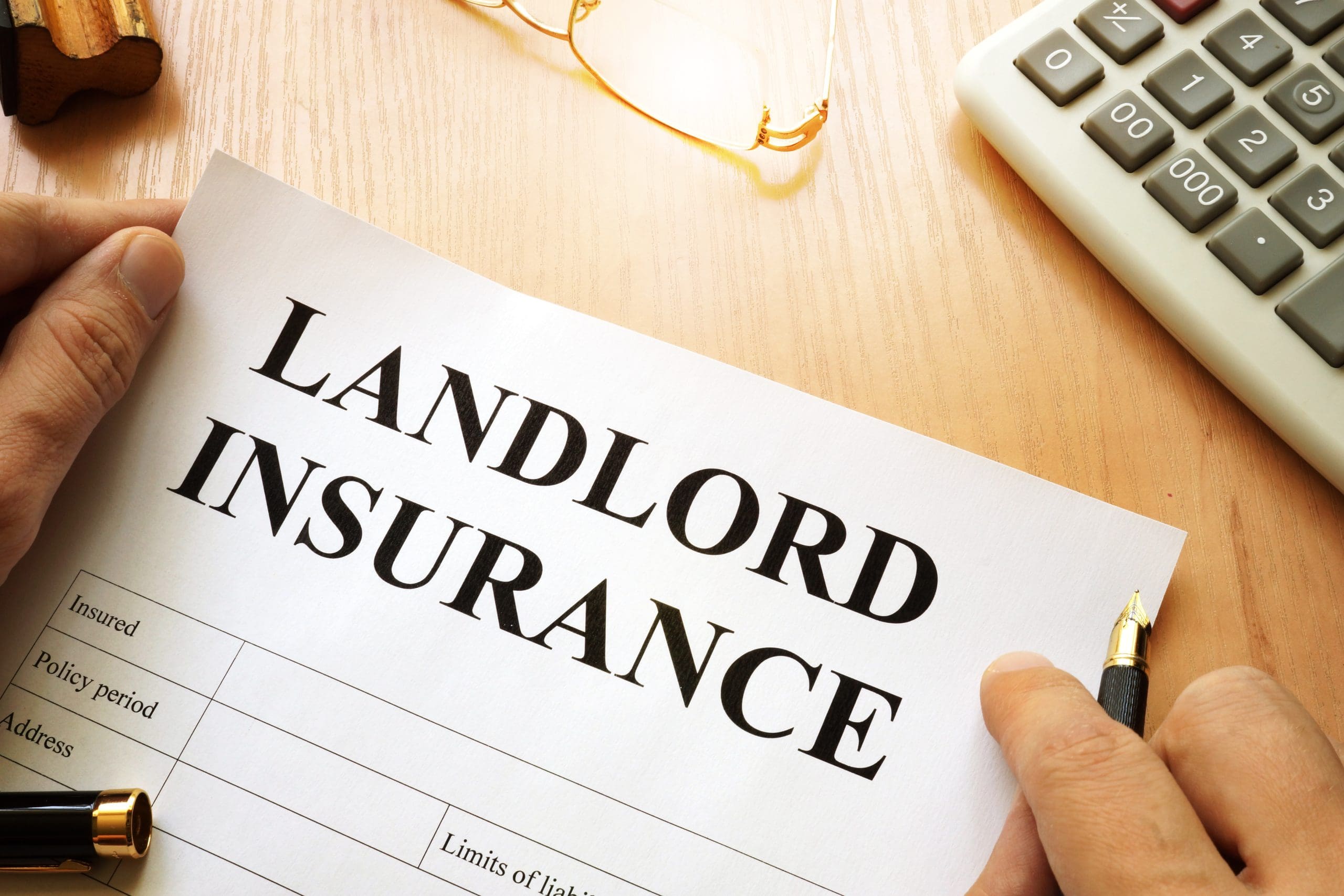 *Landlord insurance* words on a desk.